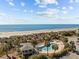 Breathtaking aerial view of the pool and pristine beach with ocean views at 1300 Ocean Blvd # 308, Isle of Palms, SC 29451