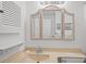 Bathroom featuring a vanity with a wicker mirror, artwork and neutral colored countertop at 1300 Ocean Blvd # 308, Isle of Palms, SC 29451