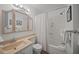 Well-lit bathroom features a coordinated vanity, toilet, and shower with white curtains, offering a clean aesthetic at 1300 Ocean Blvd # 308, Isle of Palms, SC 29451