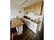 Efficient kitchen with white cabinetry, breakfast bar, and stainless steel appliances at 1300 Ocean Blvd # 308, Isle of Palms, SC 29451