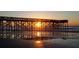 Sunrise view of pier with ocean views and reflections at 1300 Ocean Blvd # 308, Isle of Palms, SC 29451