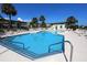 Community pool surrounded by lounge chairs and palm trees at 1300 Ocean Blvd # 308, Isle of Palms, SC 29451