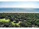 An aerial view displaying lush landscape, a golf course, and its proximity to the beach at 1365 Dunlin Court, Share D, Kiawah Island, SC 29455