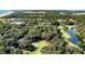 Beautiful aerial view of townhomes near Cougar Point Golf Course surrounded by tall trees and water at 1365 Dunlin Court, Share D, Kiawah Island, SC 29455