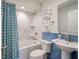 Stylish bathroom with a marble-tiled shower, blue accent tiles, and modern fixtures at 1365 Dunlin Court, Share D, Kiawah Island, SC 29455