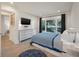 Bedroom with flatscreen TV, dresser, modern decor, and large window at 1365 Dunlin Court, Share D, Kiawah Island, SC 29455