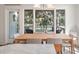 A dining area with modern fixtures and furniture, with an open view to the outdoor patio at 1365 Dunlin Court, Share D, Kiawah Island, SC 29455