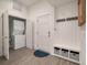 Charming entryway with a washer and dryer, storage bench, and coat rack, perfect for organization at 1365 Dunlin Court, Share D, Kiawah Island, SC 29455