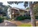 Exterior of a stylish home with multiple decks and large windows, surrounded by lush greenery at 1365 Dunlin Court, Share D, Kiawah Island, SC 29455
