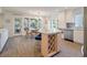Open concept kitchen with stainless steel appliances, bright lighting and dining area, and outdoor view at 1365 Dunlin Court, Share D, Kiawah Island, SC 29455