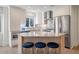Bright modern kitchen featuring stainless steel appliances, a marble countertop island and blue barstools at 1365 Dunlin Court, Share D, Kiawah Island, SC 29455