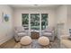 Cozy living room featuring armchairs and large windows overlooking a lush, green landscape at 1365 Dunlin Court, Share D, Kiawah Island, SC 29455
