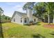 Green backyard with lawn, patio, grilling area, and mature trees at 1366 W Point Dr, Mount Pleasant, SC 29466