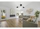 Bright living room with a gray sectional, fireplace, and modern lighting at 1366 W Point Dr, Mount Pleasant, SC 29466