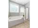 This bathroom features a tub, shower with glass door, and tile floors at 1417 Roustabout Way, Charleston, SC 29414