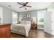 This bedroom features two windows, ceiling fan, and stylish bedside tables with lamps at 1417 Roustabout Way, Charleston, SC 29414