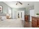 This bedroom features hardwood floors, a ceiling fan, and ensuite bath at 1417 Roustabout Way, Charleston, SC 29414
