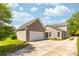 Lovely home with a two car garage and a manicured lawn and lush landscaping at 1417 Roustabout Way, Charleston, SC 29414