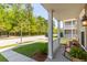 Cozy front porch with rocking chairs, offering a relaxing view of the quiet, tree-lined street at 1417 Roustabout Way, Charleston, SC 29414