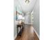 Inviting hallway with a wood floor, elegant console table, and a lovely painting creating a welcoming atmosphere at 1417 Roustabout Way, Charleston, SC 29414