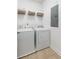 Practical laundry area includes a washer, dryer, and overhead storage solutions for efficient organization at 1417 Roustabout Way, Charleston, SC 29414