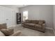 Neutral living room featuring a comfortable sofa and chair with a bookshelf and natural light from the window at 1417 Roustabout Way, Charleston, SC 29414