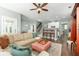 Comfortable living room, adjacent to kitchen, features a fan and access to the stairway at 1417 Roustabout Way, Charleston, SC 29414