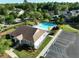 Community pool with chairs and umbrellas next to the clubhouse and parking area at 1417 Roustabout Way, Charleston, SC 29414