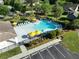 Aerial view of the community pool area with lounge chairs, umbrellas, and palm trees at 1417 Roustabout Way, Charleston, SC 29414