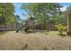 Fenced backyard featuring a wooden playset with a slide and swings, perfect for outdoor fun at 158 Whippoorwill Dr, Summerville, SC 29483