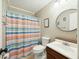 Bright bathroom featuring a vanity with dark cabinets and a shower with a colorful striped curtain at 158 Whippoorwill Dr, Summerville, SC 29483