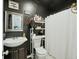Compact bathroom with black walls, a mirror, sink, and a shower at 158 Whippoorwill Dr, Summerville, SC 29483