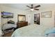 Bedroom with hardwood floors, ceiling fan, flat screen TV, and a walk-in closet at 158 Whippoorwill Dr, Summerville, SC 29483