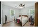 Cozy bedroom featuring wood floors, natural lighting, and a classic wood-frame bed with comfortable furnishings at 158 Whippoorwill Dr, Summerville, SC 29483