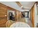 Spacious dining area featuring decorative wood paneling, laminate floors, views to kitchen and outdoor access at 158 Whippoorwill Dr, Summerville, SC 29483