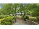 A picturesque gated driveway surrounded by lush greenery provides a private entrance to the house at 158 Whippoorwill Dr, Summerville, SC 29483