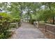 A charming gated driveway framed by lush greenery and trees, leading to a cozy home at 158 Whippoorwill Dr, Summerville, SC 29483