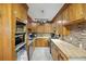 Well-lit kitchen boasting wooden cabinets, stone backsplash, and butcher block countertops at 158 Whippoorwill Dr, Summerville, SC 29483