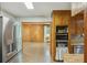 Spacious kitchen offers stainless steel refrigerator, wooden cabinetry and flooring, and an open layout to the dining area at 158 Whippoorwill Dr, Summerville, SC 29483