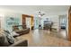 Bright living room with wood floors, a cozy sofa, and windows that allow natural light to enter the space at 158 Whippoorwill Dr, Summerville, SC 29483