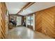 Open living room with laminate flooring, wood paneling, natural light and exterior access at 158 Whippoorwill Dr, Summerville, SC 29483