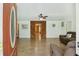 Open view from front door to living room. White walls, wood paneling, and brown sofas create a warm atmosphere at 158 Whippoorwill Dr, Summerville, SC 29483
