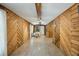 Large living room area featuring wood paneling, laminate floors, and a charming dining space at 158 Whippoorwill Dr, Summerville, SC 29483