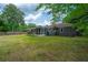 Expansive backyard featuring a well-maintained lawn, brick home, and a screened-in porch, perfect for outdoor activities and relaxation at 1707 Sharon Ave, Charleston, SC 29407