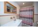 Bathroom featuring floral wallpaper, tiled walls and enclosed shower at 1707 Sharon Ave, Charleston, SC 29407