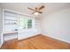 Bedroom featuring hardwood floors, built-in shelving, desk, and large window at 1707 Sharon Ave, Charleston, SC 29407