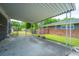 Covered carport with a brick home in the background, offering convenient parking and protection from the elements at 1707 Sharon Ave, Charleston, SC 29407