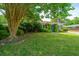 Charming single-story home framed by a lush green lawn and mature trees at 1707 Sharon Ave, Charleston, SC 29407