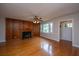 Inviting living area featuring hardwood floors, a wood-paneled wall, and a classic fireplace at 1707 Sharon Ave, Charleston, SC 29407