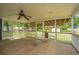 Screened-in porch with ceiling fan, perfect for relaxing and enjoying the view of the lush backyard and neighborhood at 1707 Sharon Ave, Charleston, SC 29407